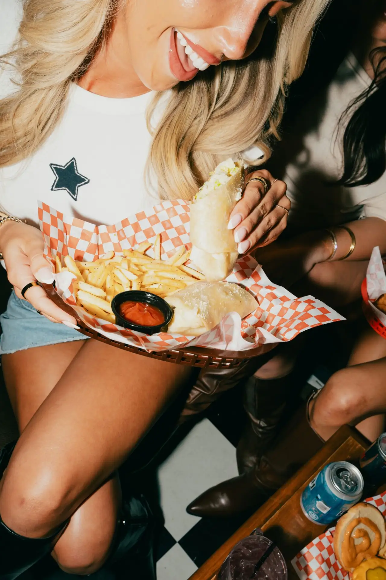 A Caesar wrap and fries in a checkered basket